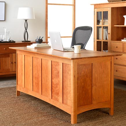 A home office with a desk and bookshelves.