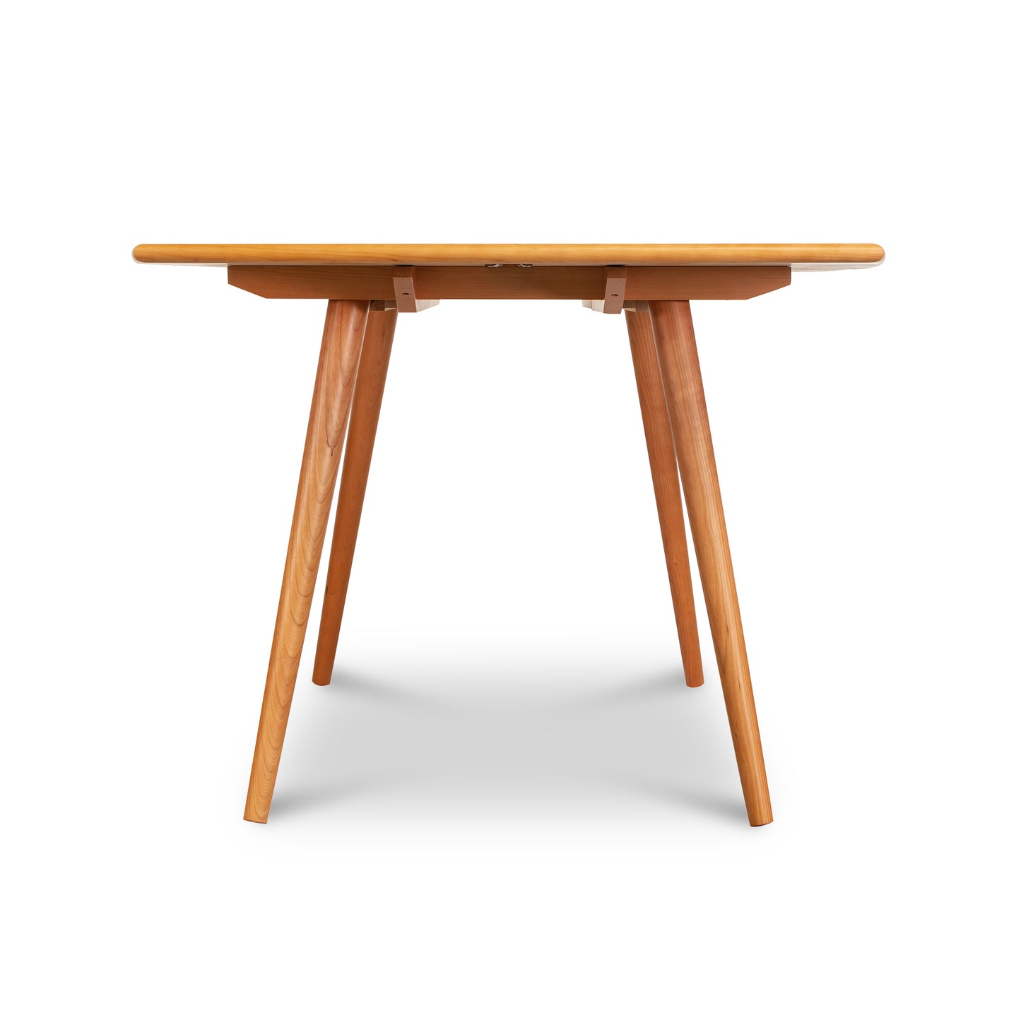 Vermont-crafted Addison Boat Top Extension Dining Table with round top and angled legs by Lyndon Furniture, viewed straight-on.