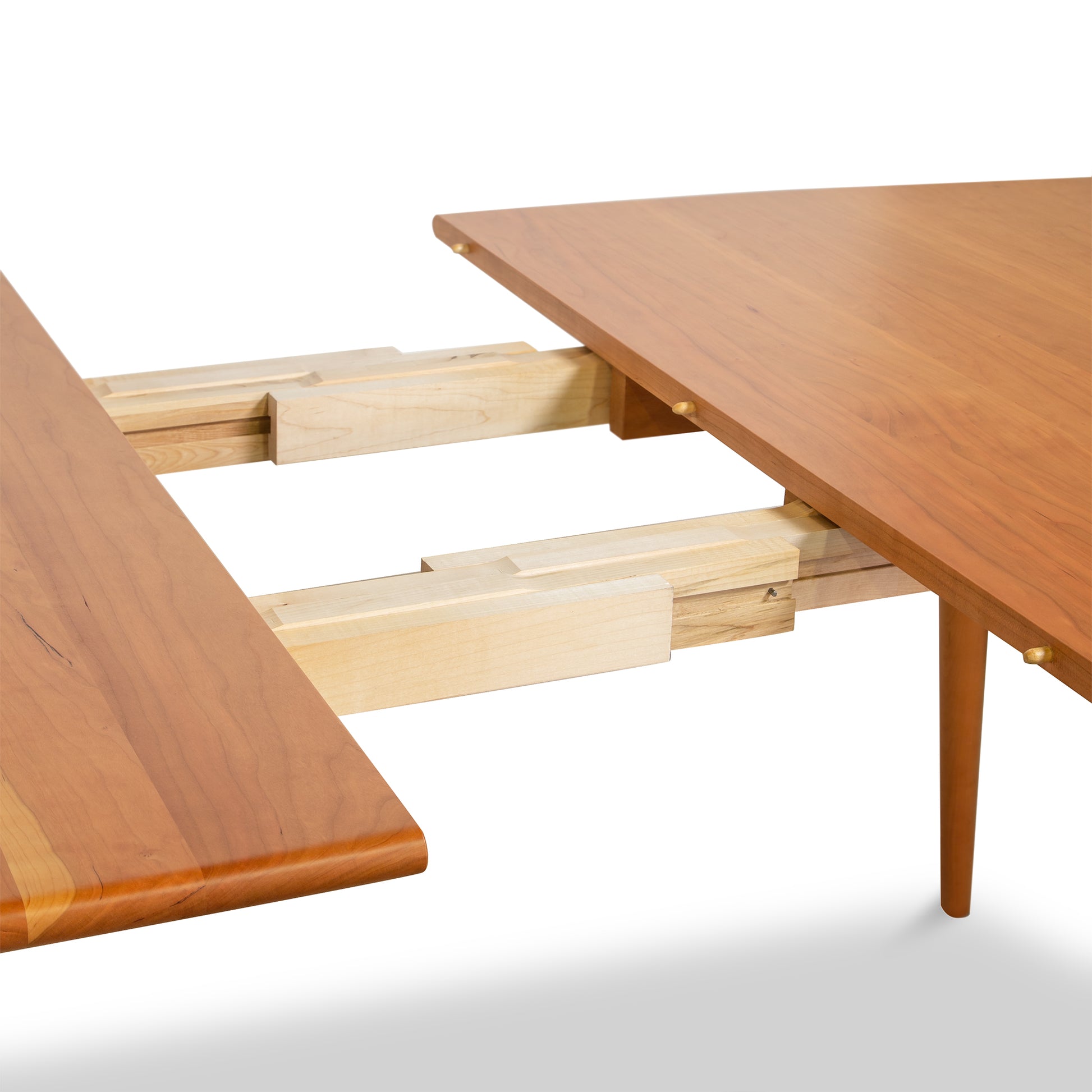 A mid-century modern dining room table with a wooden top from Lyndon Furniture's Addison Boat Top Extension Dining Table - Floor Model.