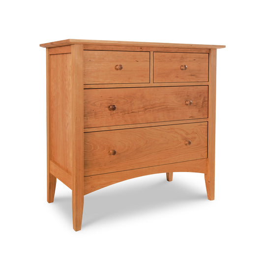 A solid wood chest with four drawers, featuring a simple design from the Maple Corner Woodworks American Shaker Furniture Collection, placed against a white background.