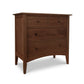 A wooden dresser from the Maple Corner Woodworks American Shaker 4-Drawer Chest, with four drawers and tapered legs, isolated on a white background. The dresser has a rich brown finish and simple round knobs.