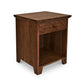 A small wooden nightstand in American Country style, the American Country 1-Drawer Enclosed Shelf Nightstand by Lyndon Furniture.