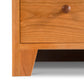 A close up of a Lyndon Furniture American Country 6-Drawer Dresser, made of solid wood.