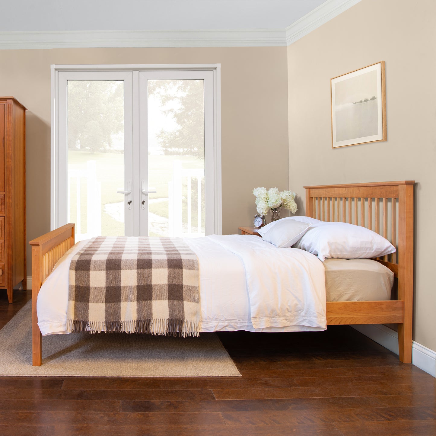Lyndon Furniture American Mission Bed featuring white bedding and a plaid blanket, showcasing handcrafted wood design.