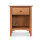 A natural cherry American Shaker 1-Drawer Enclosed Shelf Nightstand designed in the American Shaker style, featuring a single drawer with a circular knob on top and an open shelf space below, set against a plain white background. Created by Maple Corner Woodworks.