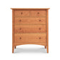 A Maple Corner Woodworks American Shaker 5-Drawer Chest crafted from sustainably harvested wood, with a natural finish and simple, round knobs, set against a plain white background. The dresser features a smaller split top drawer and four