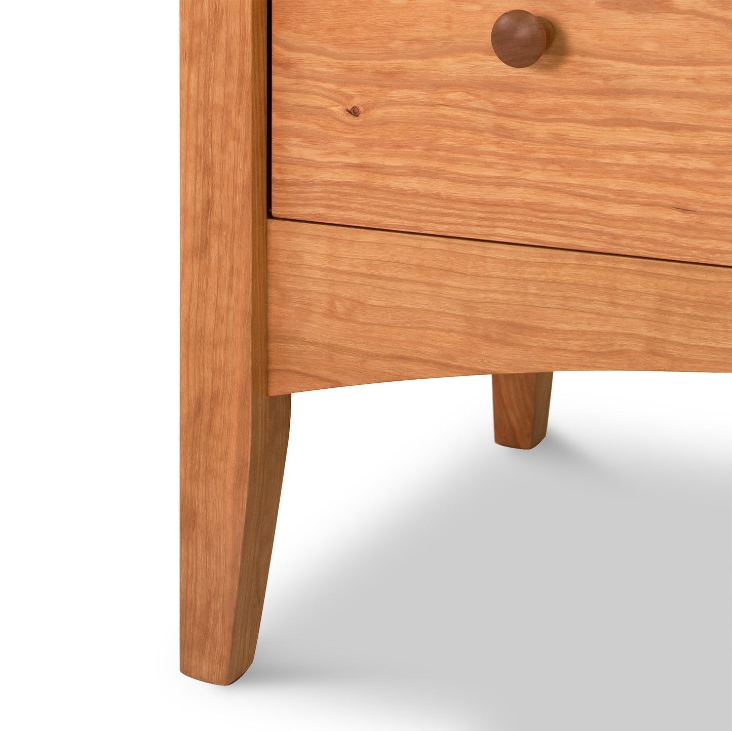 Close-up of a handcrafted solid wood cabinet from Maple Corner Woodworks' American Shaker 5-Drawer Chest featuring a visible drawer with a round knob.