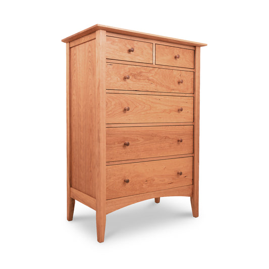 A Maple Corner Woodworks American Shaker 6-Drawer Chest, featuring varying drawer sizes and round knobs, crafted from sustainably-harvested natural solid wood, isolated on a white background.