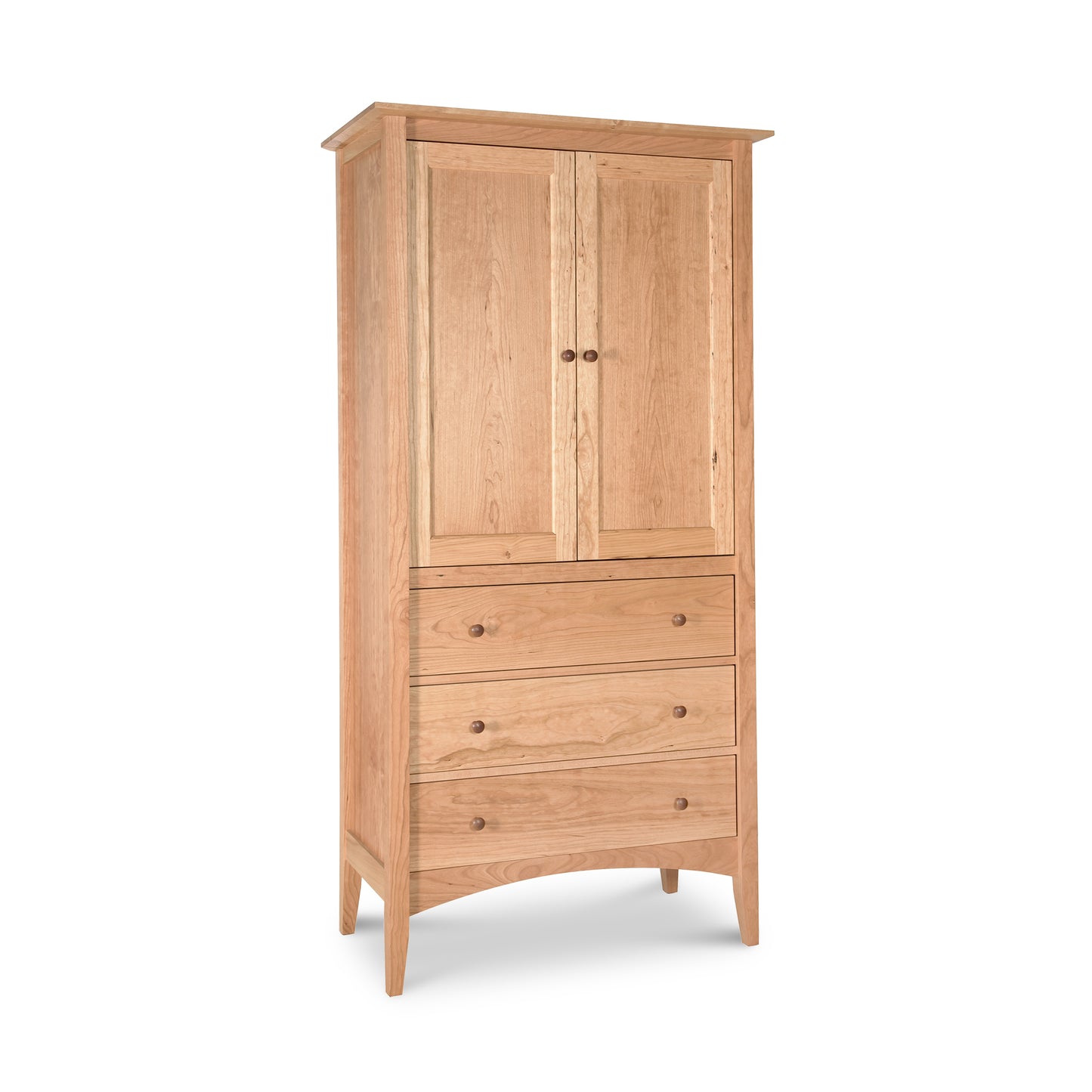 A Maple Corner Woodworks American Shaker Armoire with a two-door cabinet on top and three drawers below, all on tapered legs. The wood has a light natural finish and the hardware is minimalistic. This heirloom quality furniture.