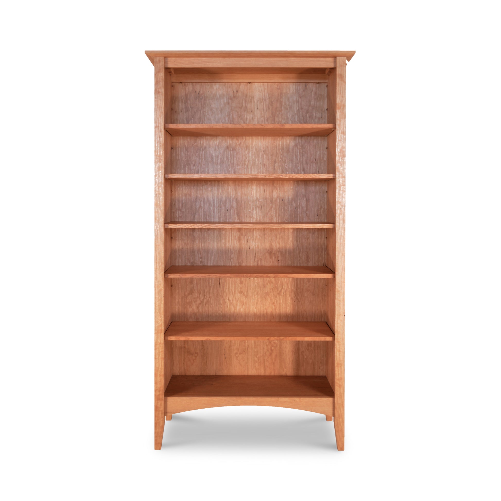 An American Shaker bookcase from Maple Corner Woodworks crafted from sustainably harvested hardwoods, with empty shelves isolated against a white background.