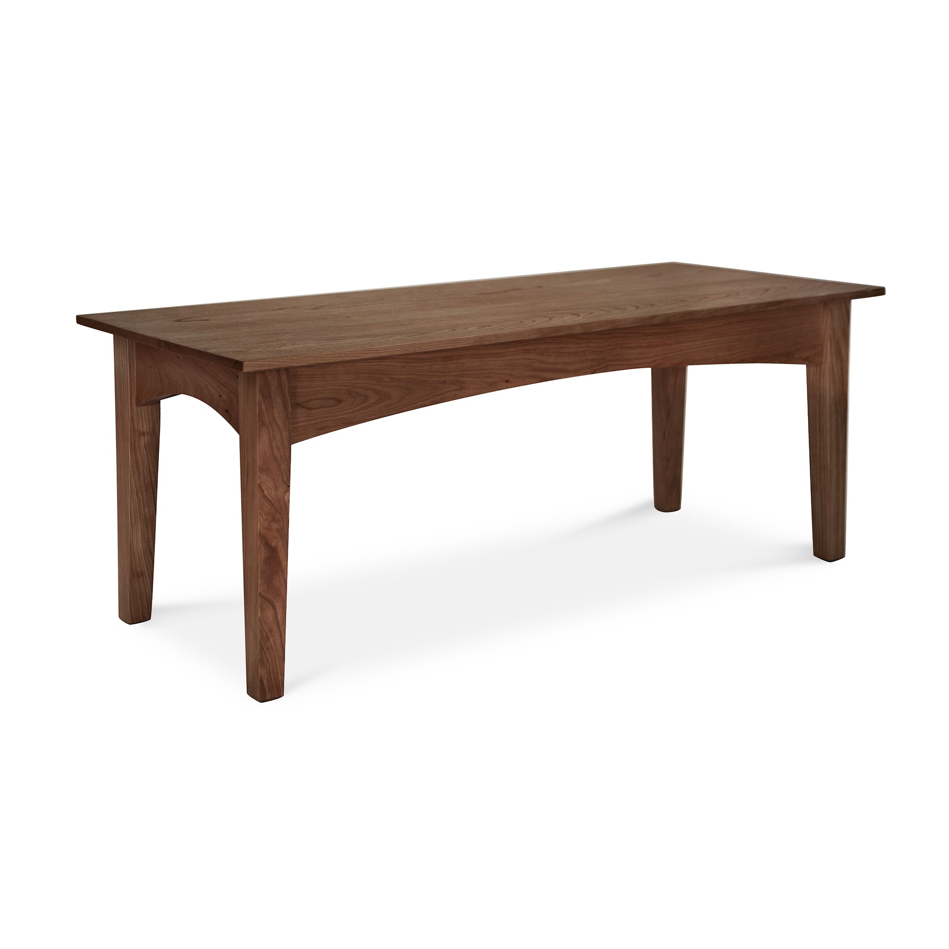 A simple, rectangular American Shaker Coffee Table by Maple Corner Woodworks with four sturdy legs, isolated on a white background. The coffee table is made of solid hardwood, featuring a rich, brown wood with visible grain patterns.