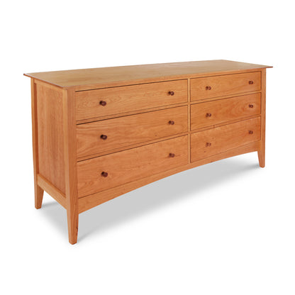 A Maple Corner Woodworks American Shaker 6-Drawer Dresser, featuring a simple, elegant American Shaker design and tapered legs. The dresser is set against a plain white background.