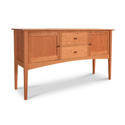 A American Shaker Huntboard from Maple Corner Woodworks with three drawers in the center flanked by two cabinet doors, all featuring round knobs. The furniture stands on slender, tapered legs and has a smooth, natural cherry finish.