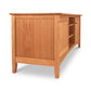 A Maple Corner Woodworks American Shaker 67" TV Stand with a natural finish, featuring two doors and a visible interior shelf on one side, crafted from solid hardwoods and isolated on a white background.