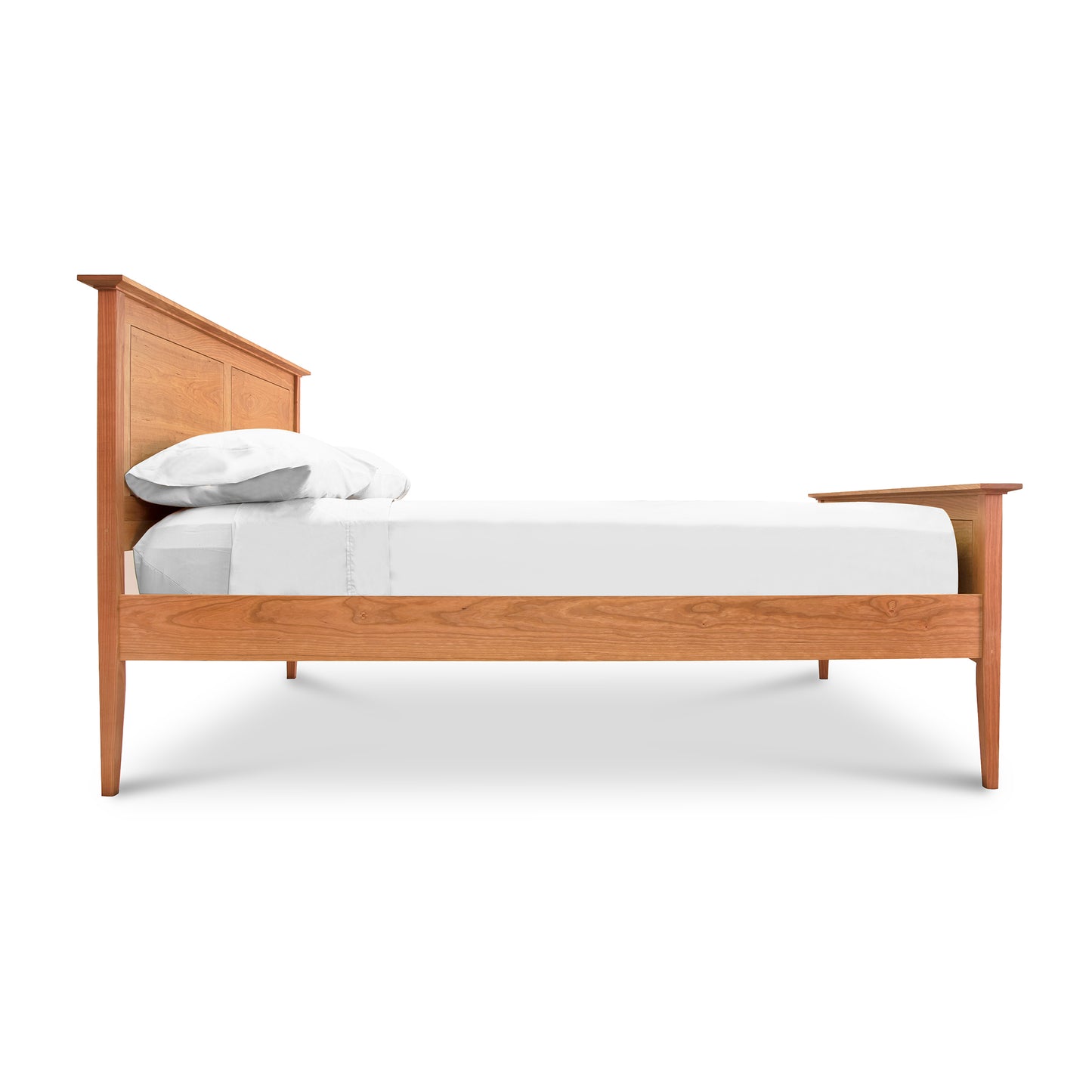 A Maple Corner Woodworks American Shaker Panel Bed frame with a classic design featuring a high headboard and a low footboard, equipped with a white mattress and two pillows. The bed is isolated on a white background.
