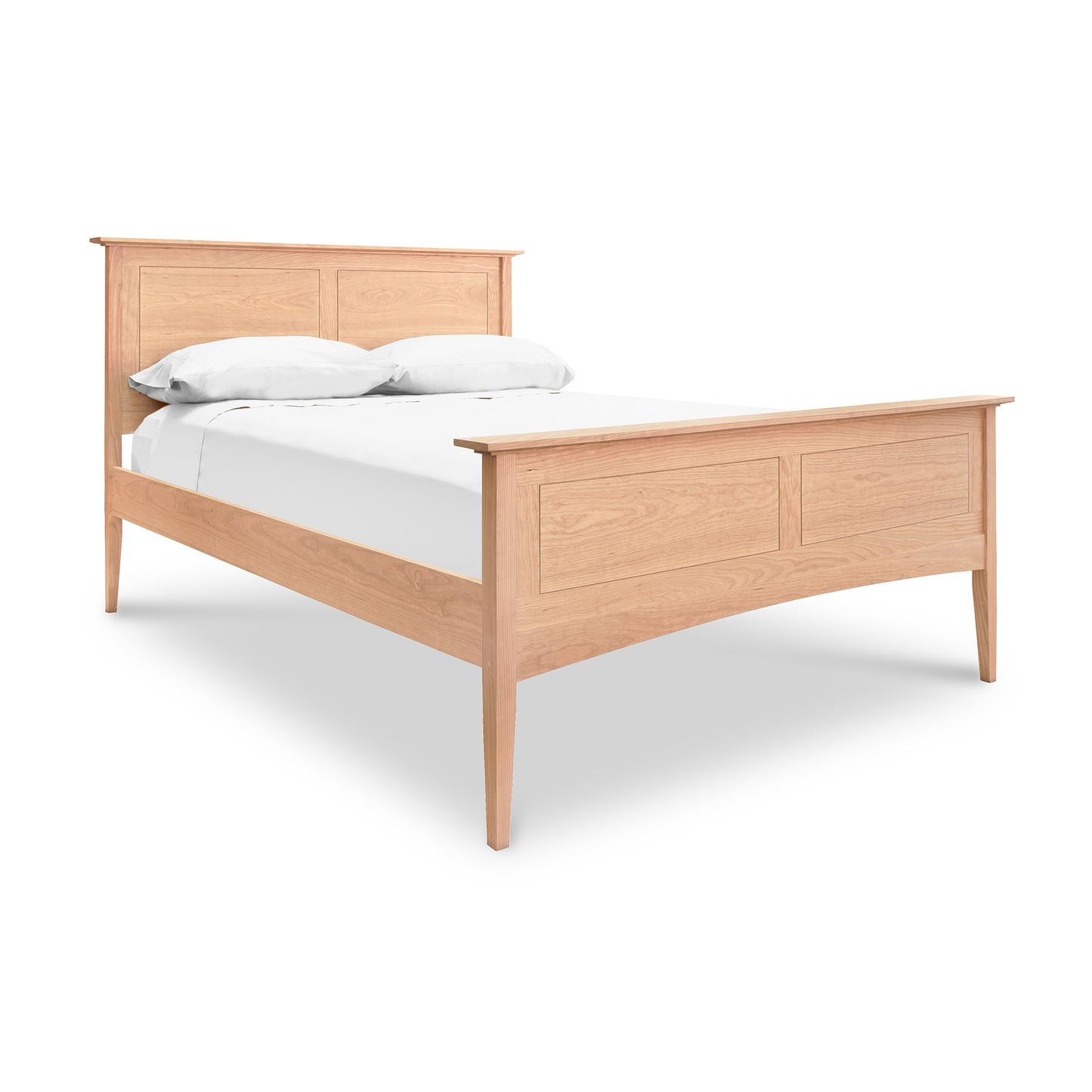 A handmade American Shaker Panel Bed from Maple Corner Woodworks, crafted from sustainably harvested woods, complete with white bedding and pillows, isolated on a white background.