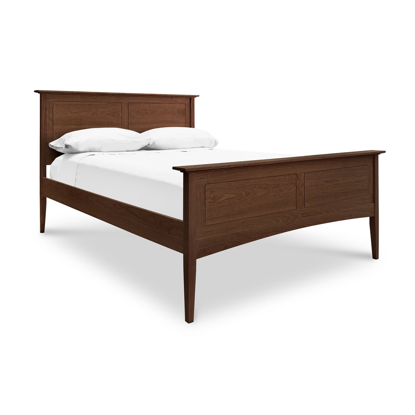A Maple Corner Woodworks American Shaker Panel Bed with a prominent headboard and a matching footboard, both featuring shaker panel designs. The bed is dressed with plain white bedding.