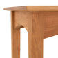Close-up view of a American Shaker Sofa Table corner showing the tabletop and the joint of a leg from Maple Corner Woodworks' eco-friendly solid wood furniture collection with a white background.