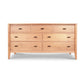 An eco-friendly Andover Modern 7-Drawer Dresser with seven drawers and round handles, featuring a natural cherry finish and angled legs, isolated on a white background. (Maple Corner Woodworks)