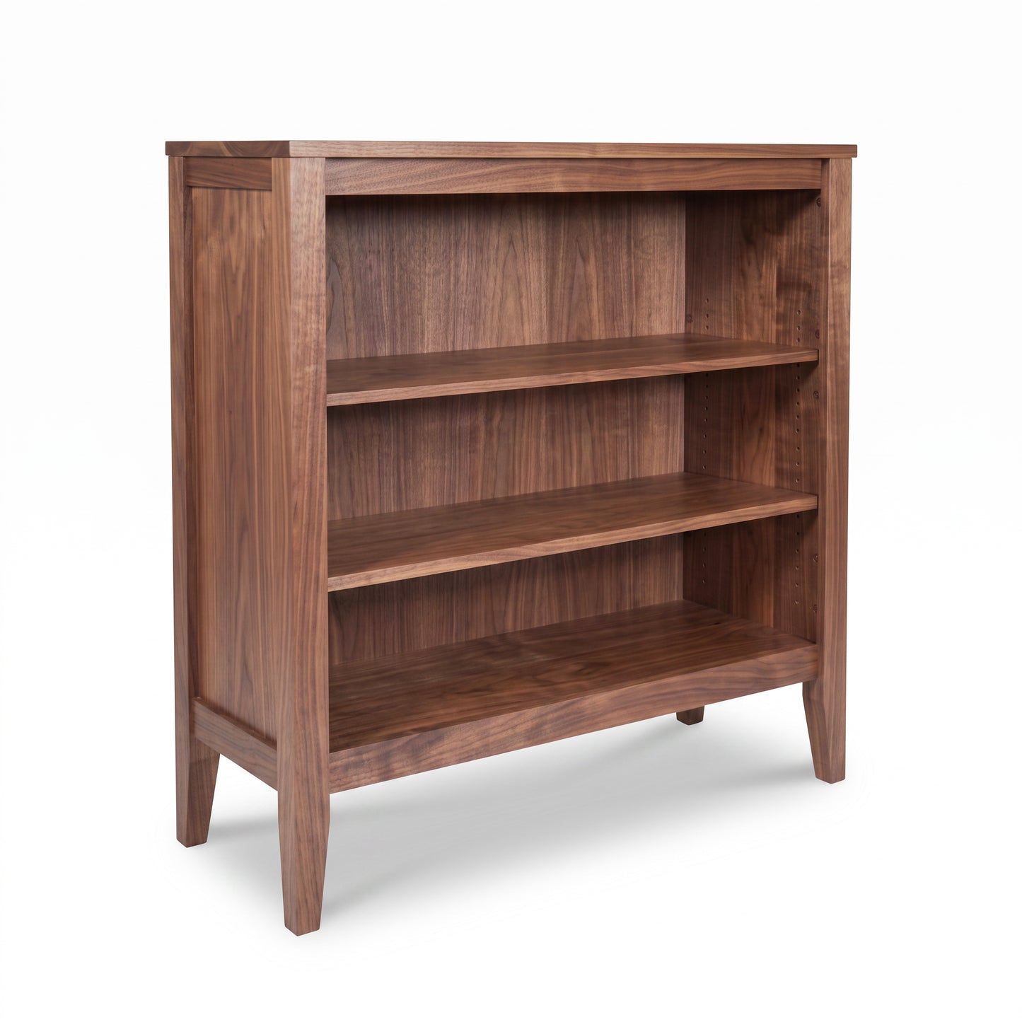 The Andover Modern Bookcase by Maple Corner Woodworks features three solid wood shelves and four legs, crafted in American hardwood.