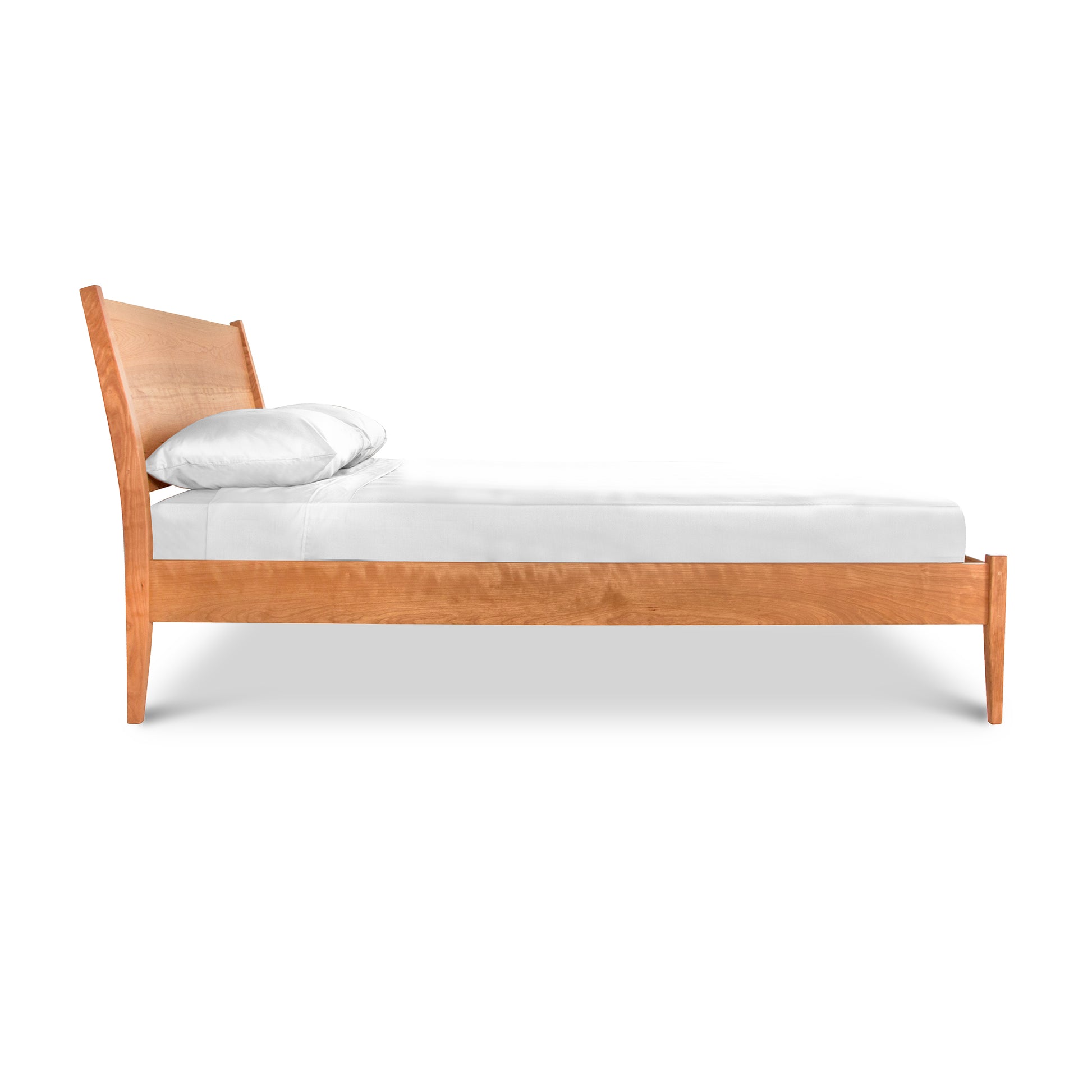 A Maple Corner Woodworks Andover Modern Incline Bed with a slanted headboard and a single white pillow on a white mattress, isolated against a white background.