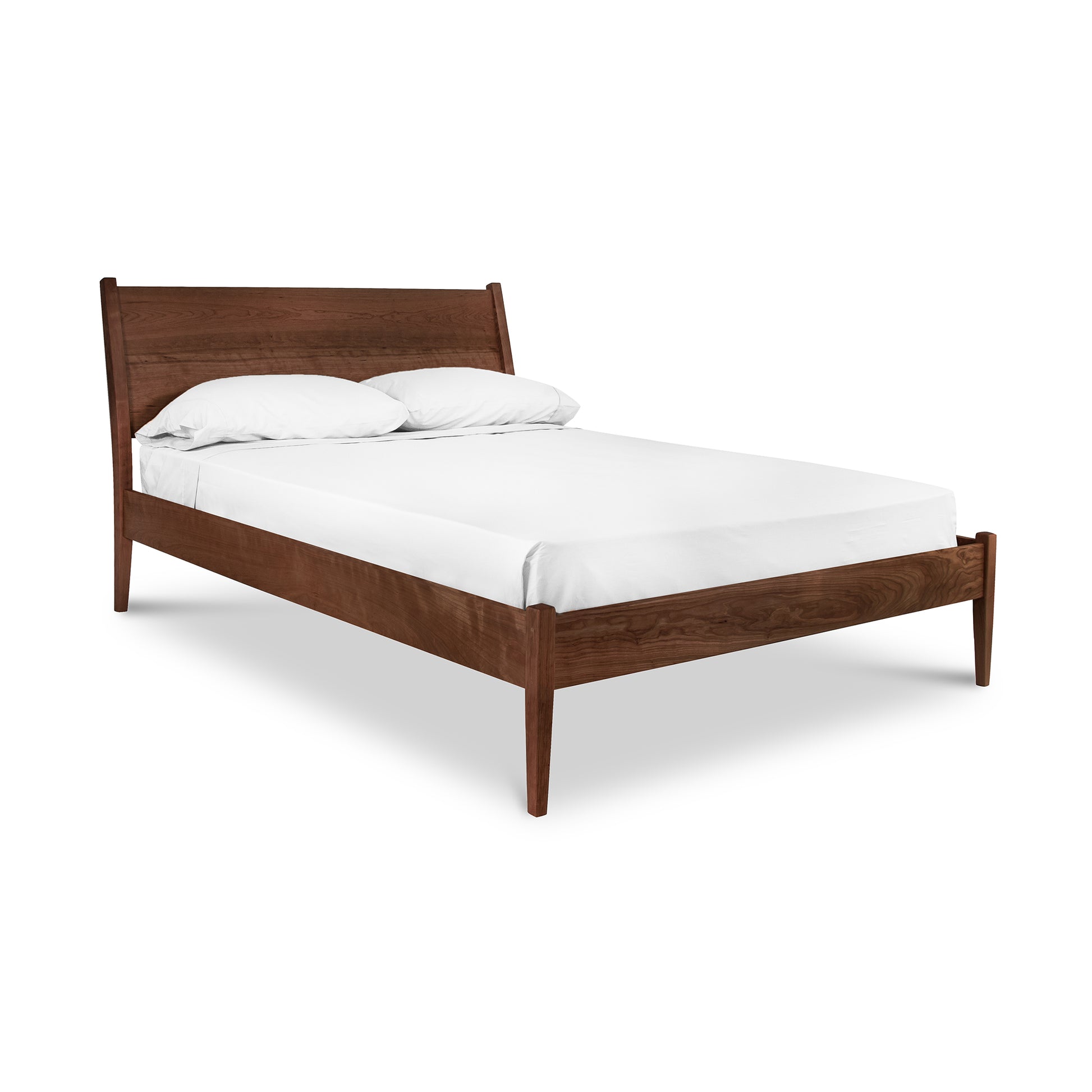 A Maple Corner Woodworks Andover Modern Incline Bed frame with a sloped headboard, supporting a white mattress and two pillows, isolated on a white background.