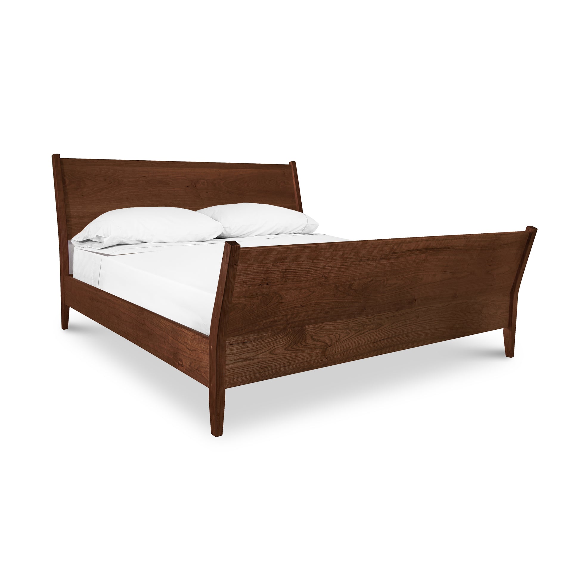 A Maple Corner Woodworks Andover Modern Incline Sleigh Bed with a curved headboard and footboard, furnished with white bedding, isolated on a white background.
