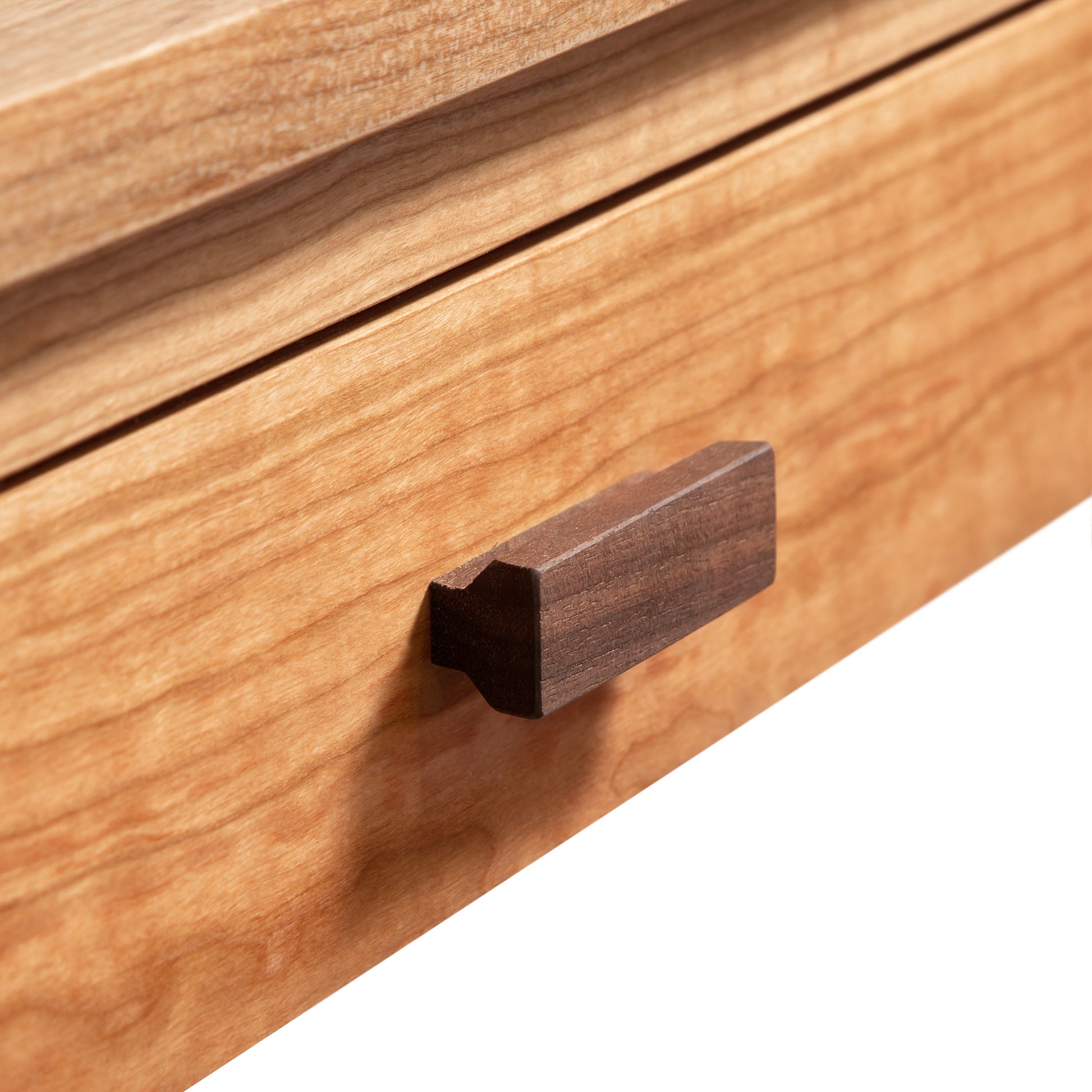 Close-up of a Maple Corner Woodworks Andover Modern Writing Desk with a simple, dark-toned knob.