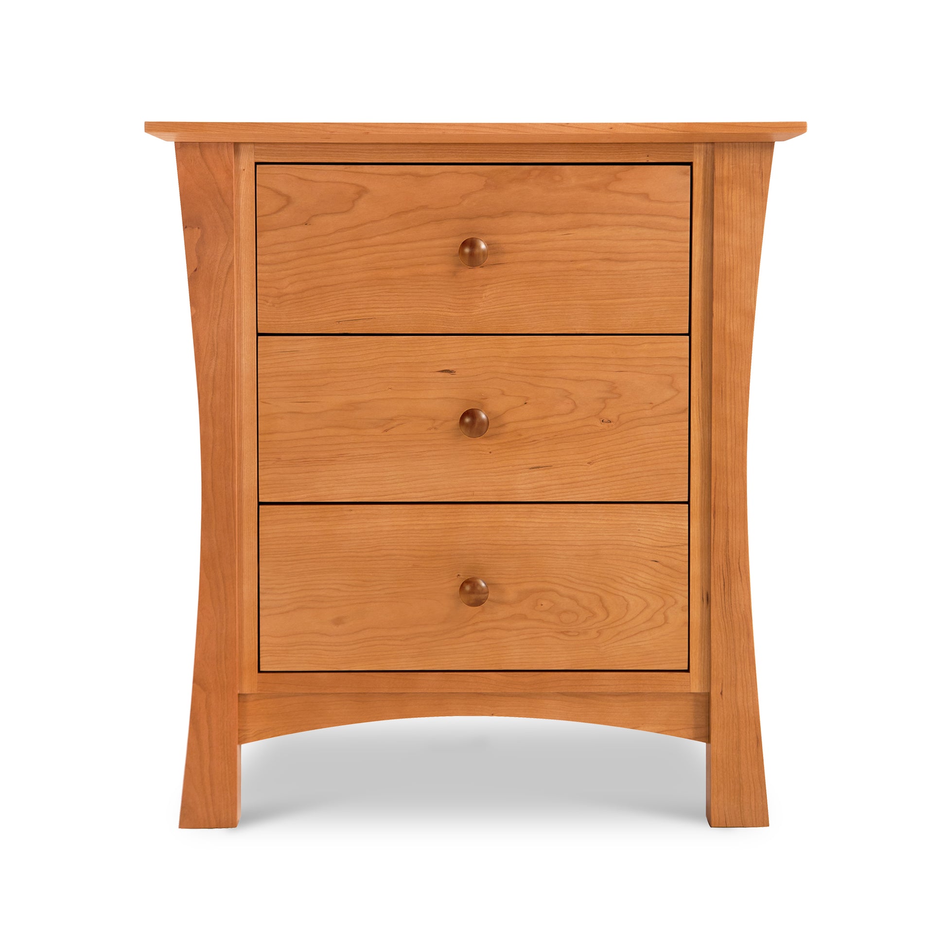 Lyndon Furniture Andrews 3-Drawer Nightstand in natural cherry with round knobs and flared legs, highlighting its craftsmanship and elegant wood finish.