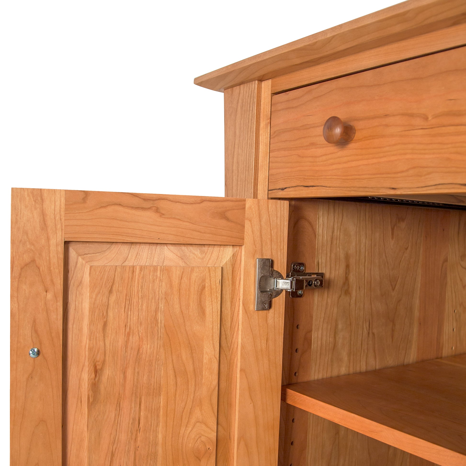 Close-up of the Andrews Buffet by Lyndon Furniture highlighting its sturdy drawer with round knob, visible metal hinge, and spacious lower shelf.