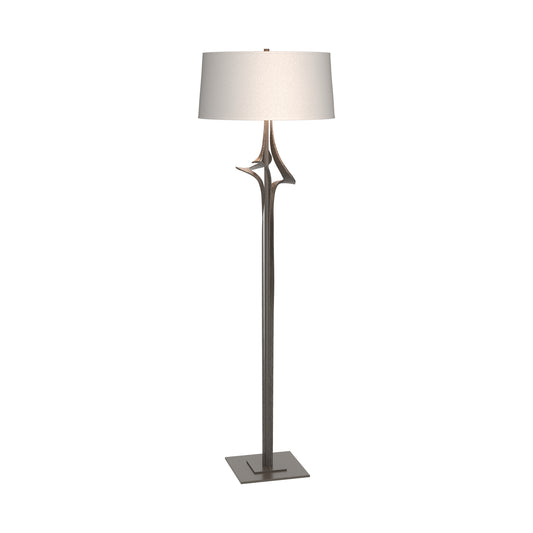 Antasia Floor Lamp by Hubbardton Forge with a sculptural forked metallic stand, white shade, and square base, showcasing elegant American-made craftsmanship.
