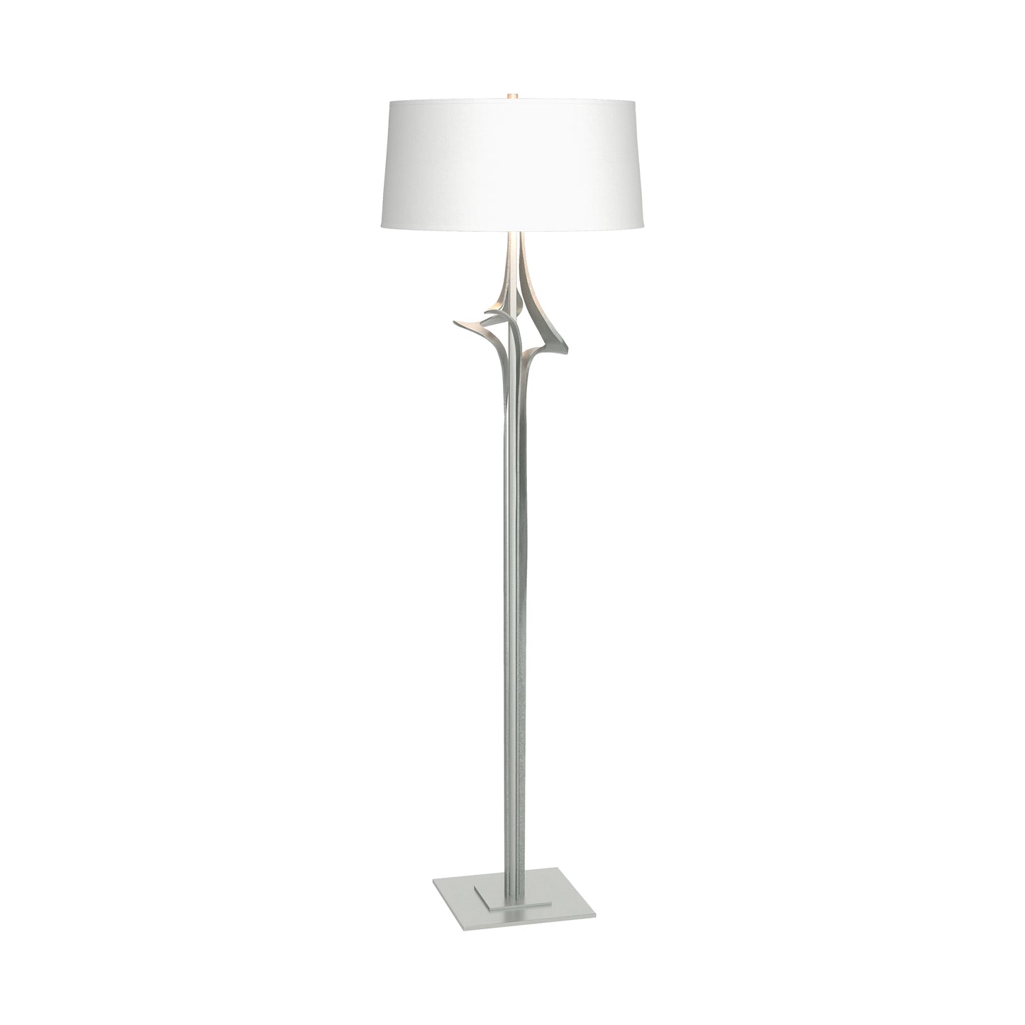Antasia Floor Lamp by Hubbardton Forge with a sculptural metallic stem, square base, and white drum shade, showcasing elegant modern design.