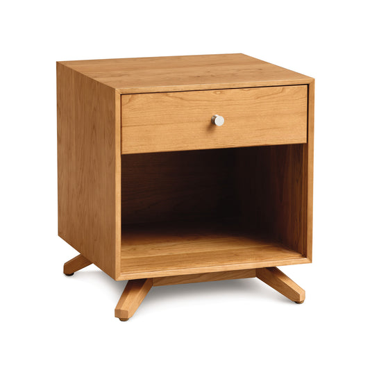 A Copeland Furniture Astrid 1-Drawer Enclosed Shelf Nightstand with a single drawer and an open shelf on angled legs, designed with a modern aesthetic against a white background.