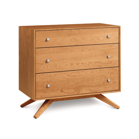 Copeland Furniture's Astrid 3-Drawer Chest, a mid-century modern wooden dresser with angled legs, isolated on a white background.