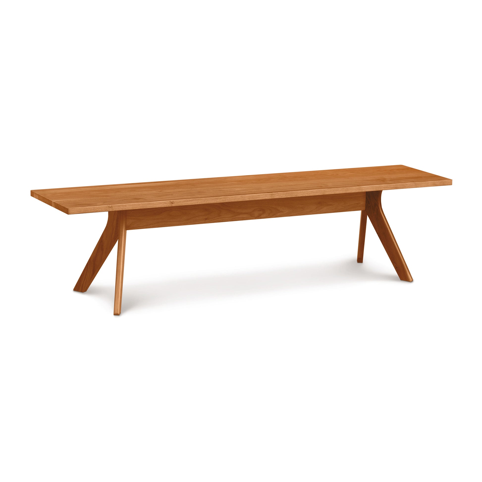 Audrey Dining Bench by Copeland Furniture, modern design with distinctive angled legs, crafted from solid wood, highlighted against a plain white background.