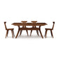 A modern solid cherry wood Audrey Extension dining table set with four Copeland Furniture chairs on a white background.