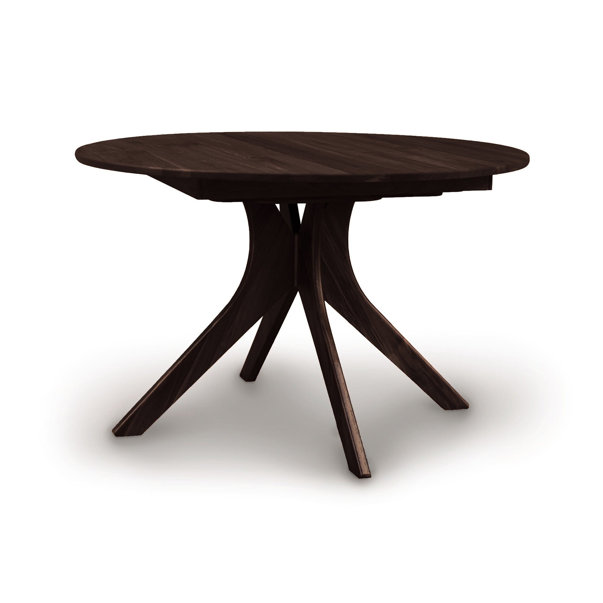 Audrey Round Extension Dining Table by Copeland Furniture, crafted from dark solid wood with four angled legs, showcasing a modern design.