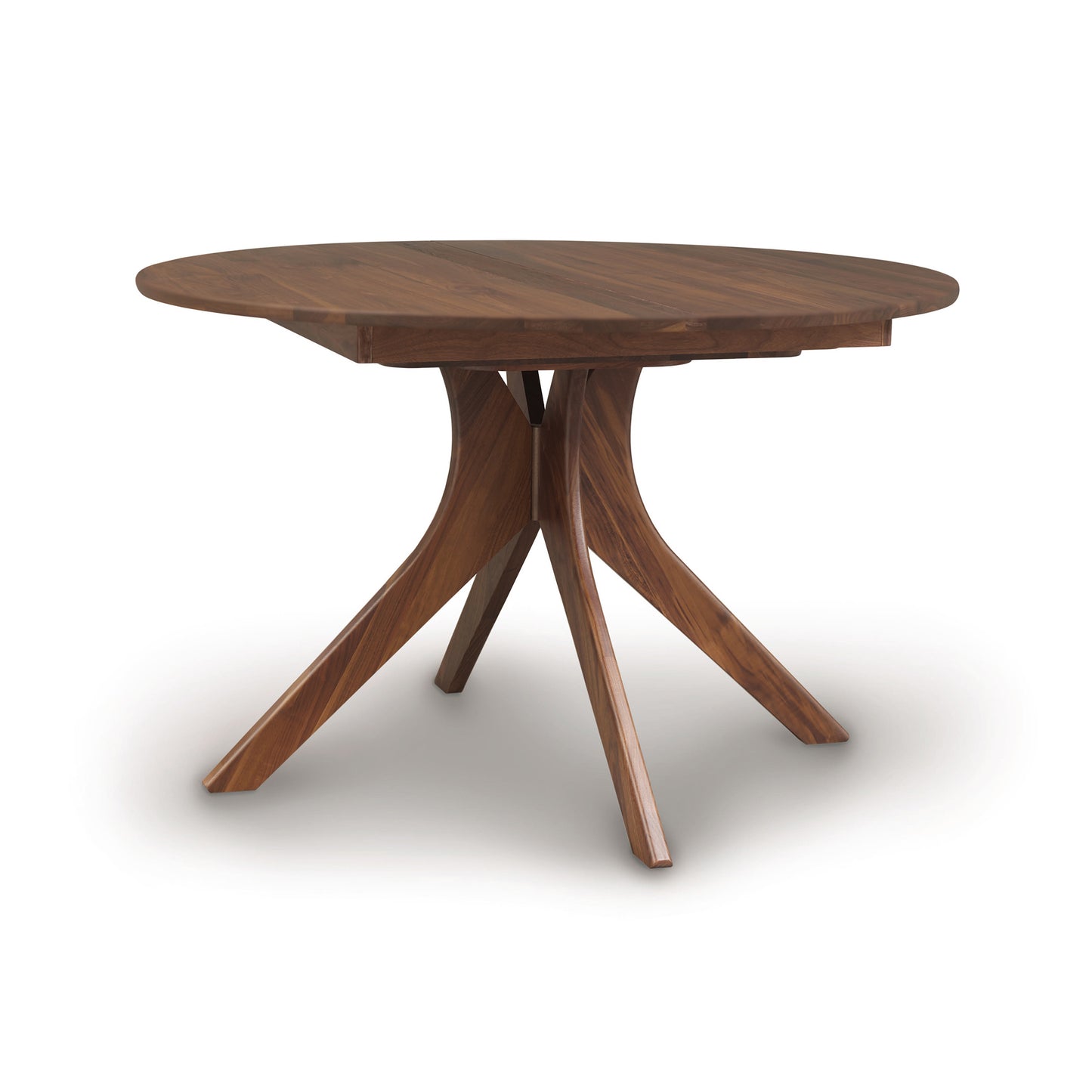 Audrey Round Extension Dining Table by Copeland Furniture with a natural wood top and angled legs, highlighting its elegant craftsmanship.