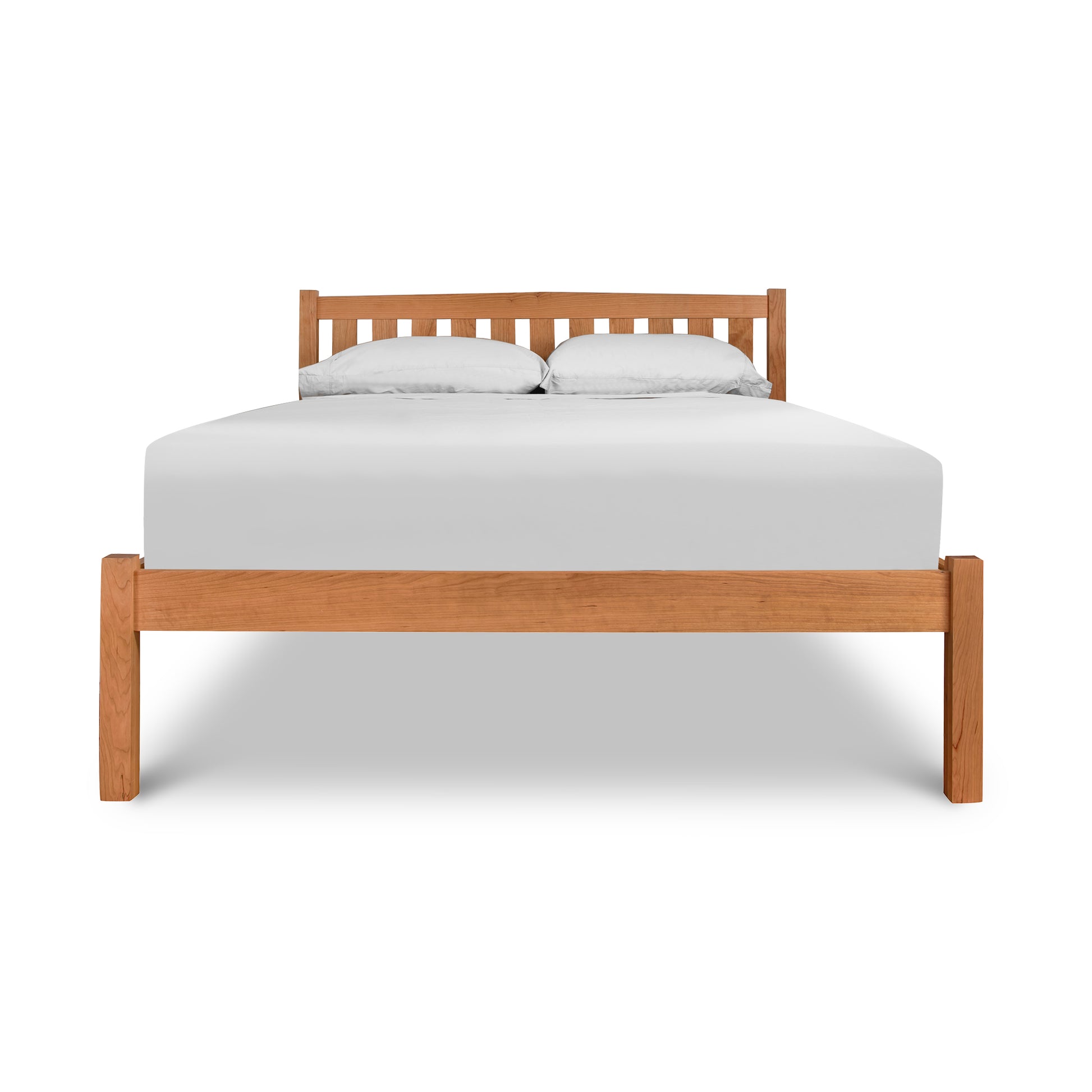 Bennington Bed by Vermont Furniture Designs, showcasing elegant wooden craftsmanship with a white mattress and two pillows.