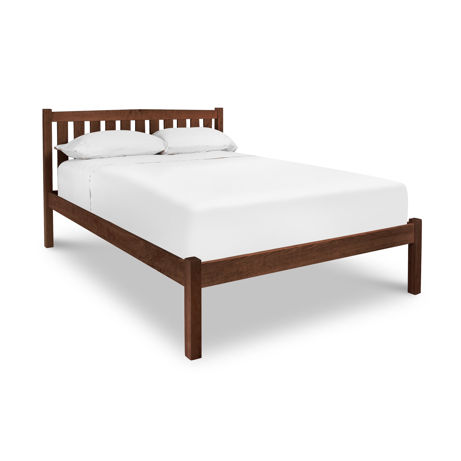 Solid wood platform bed with slatted headboard, showcasing craftsmanship similar to Vermont's Bennington Bed.