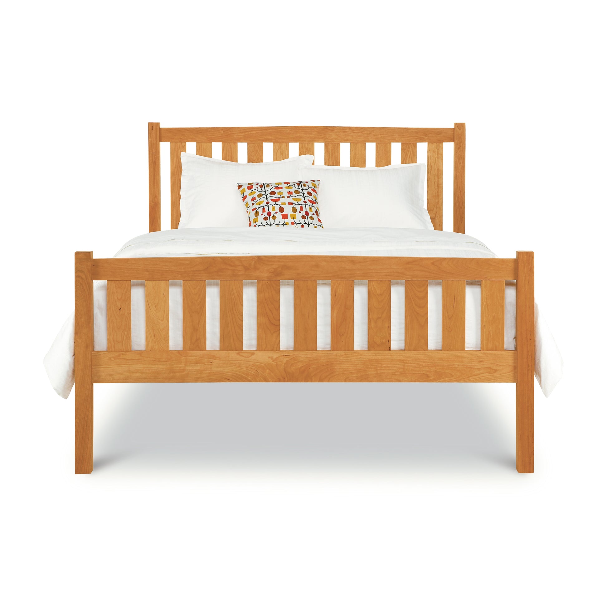 A Vermont Furniture Designs Bennington Bed with High Footboard with a white bedding set and a single decorative pillow against a white background.