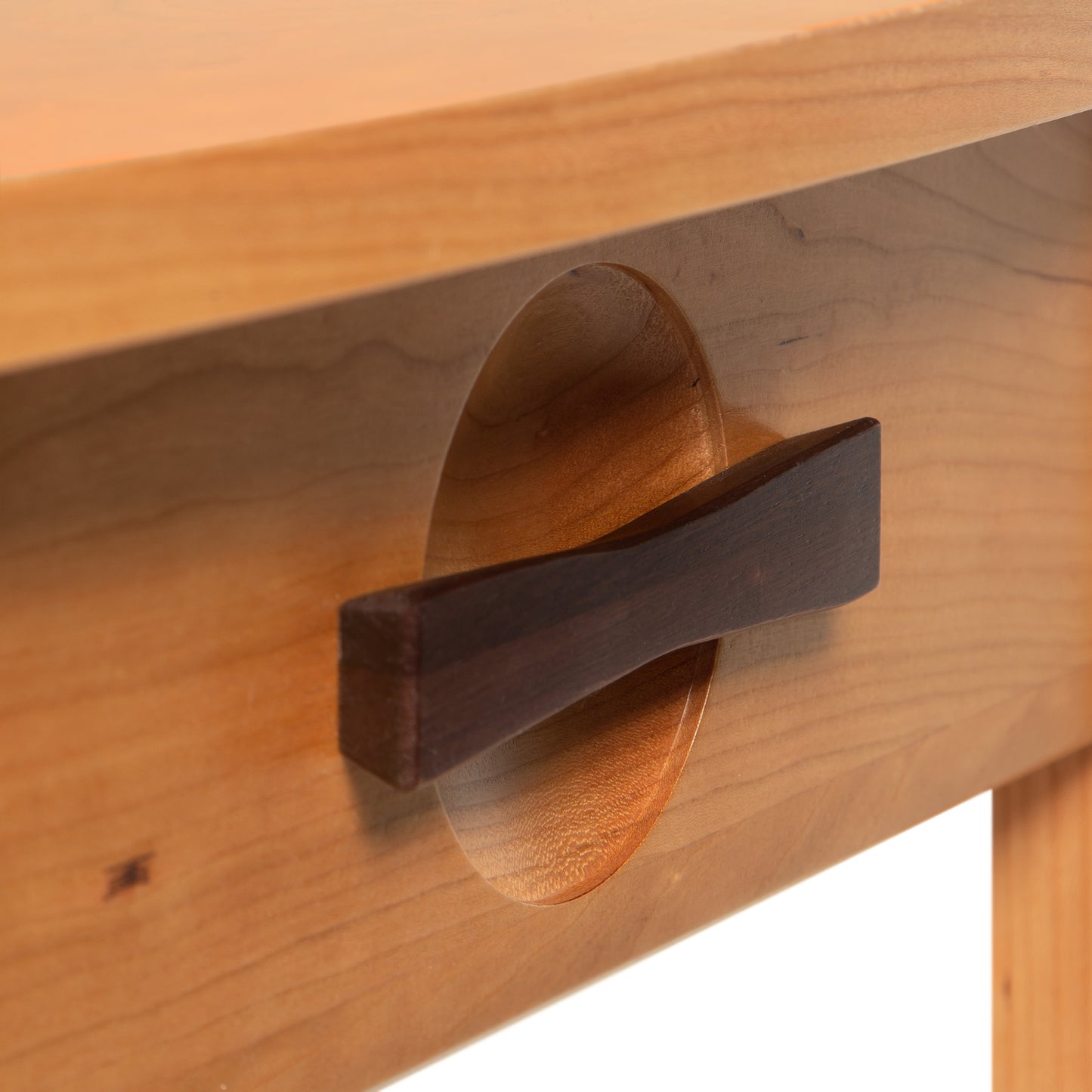 Close-up of Copeland Furniture Berkeley nightstand's cherry wood drawer featuring a sleek curved dark brown handle.