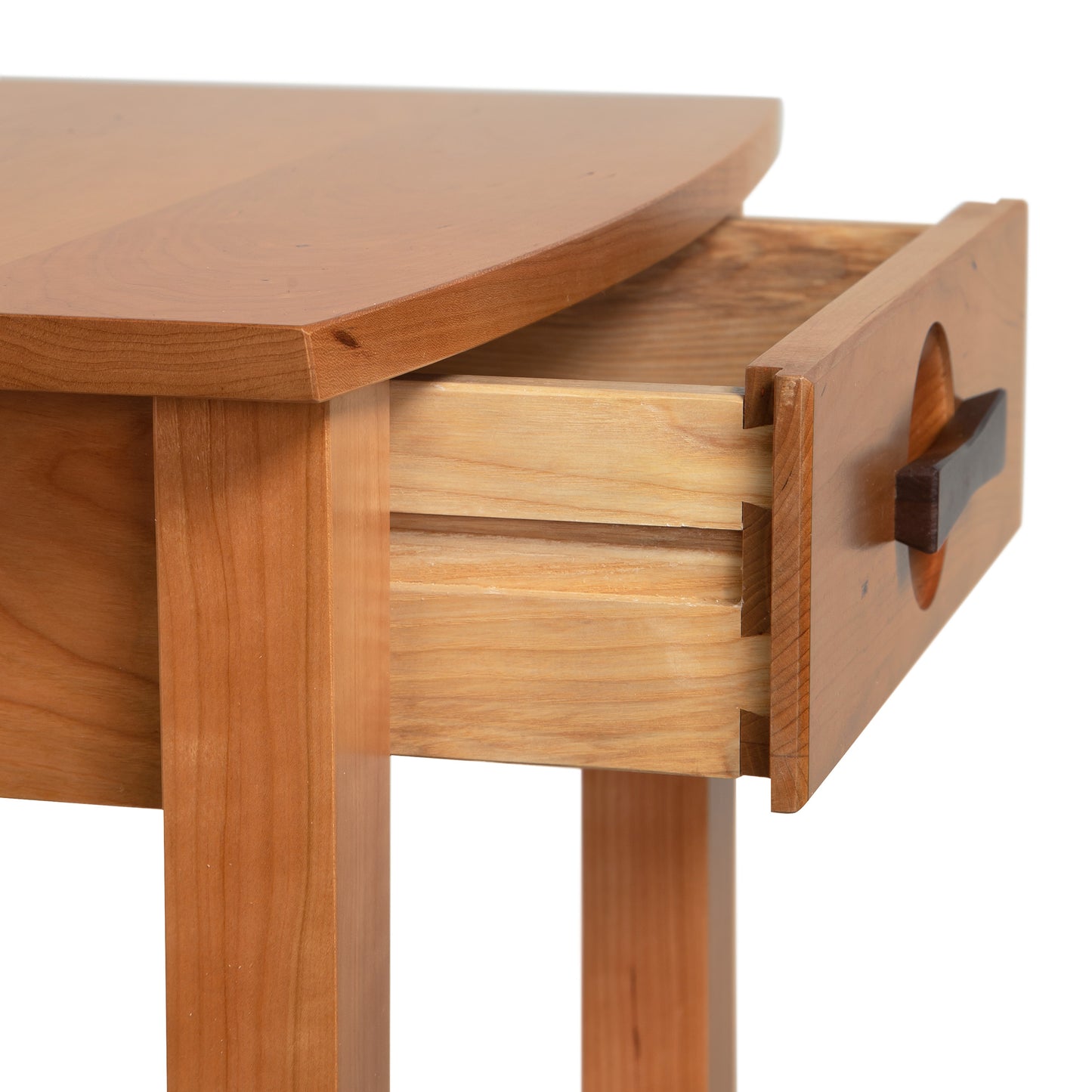 The Berkeley Nightstand by Copeland Furniture, crafted in Vermont, showcases a light cherry wood finish with a dark handle and dovetail joint open drawer.