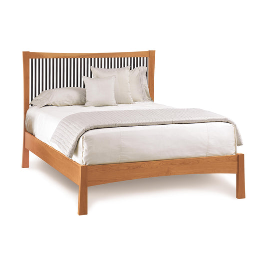 Berkeley Cherry Platform Bed frame with a slatted headboard, dressed with white bedding and pillows, isolated on a white background, reflecting the American Craftsman style.