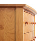 A close up of a Lyndon Furniture Bow Front 6-Drawer Dresser.