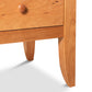A Lyndon Furniture Bow Front 8-Drawer Dresser nightstand with a drawer.