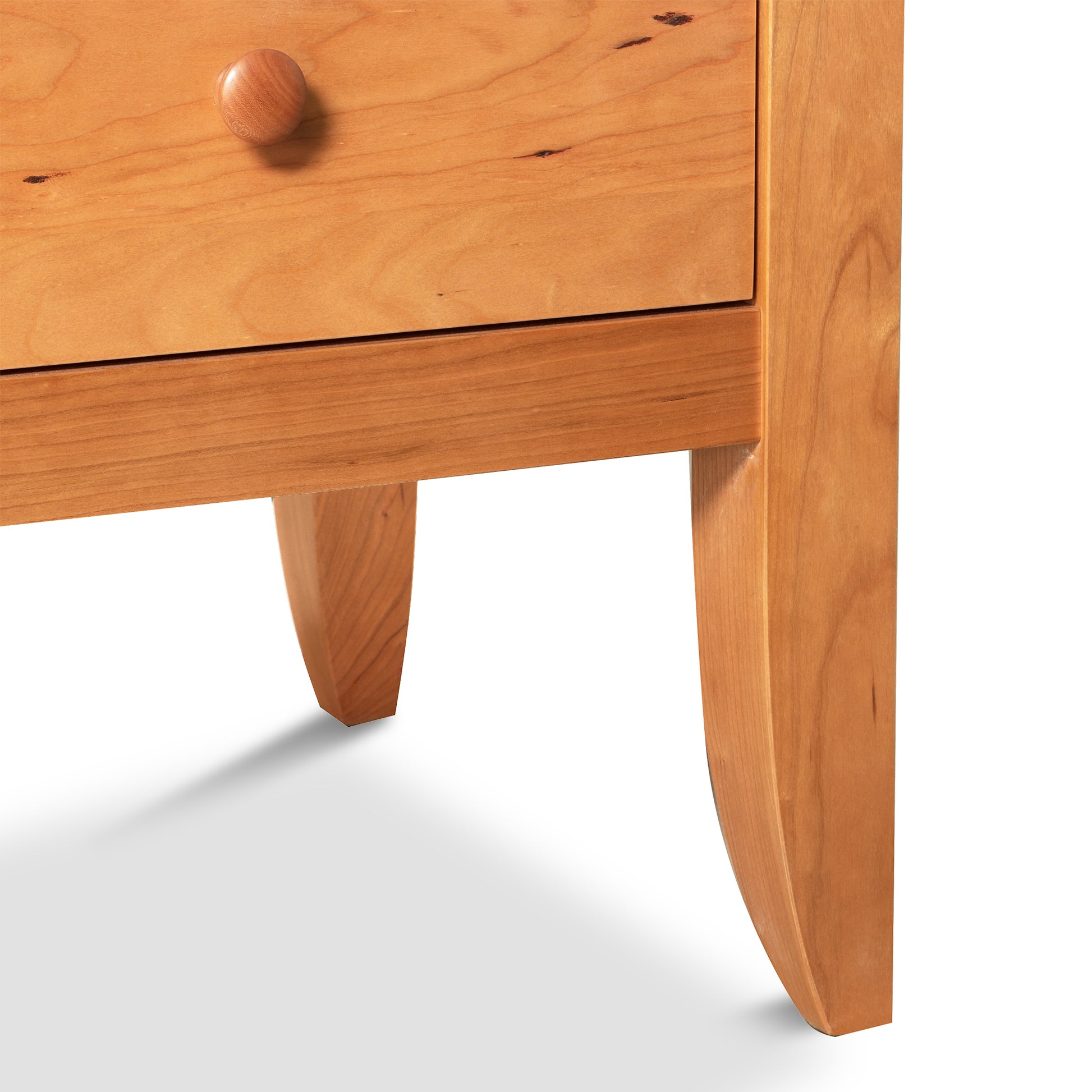 A Lyndon Furniture Bow Front 8-Drawer Dresser nightstand with a drawer.