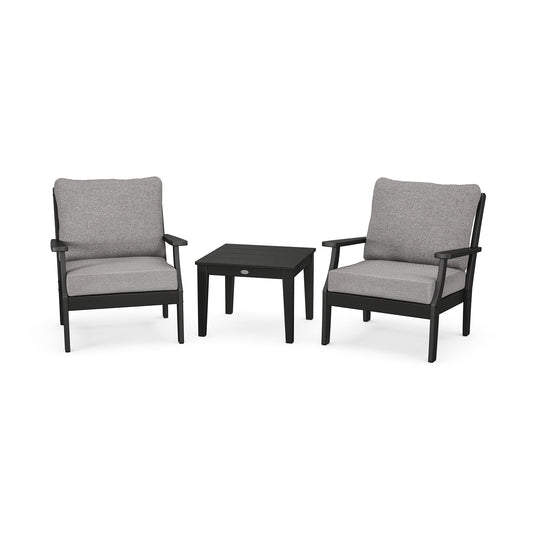 Elegant outdoor seating with two POLYWOOD Braxton chairs showcasing gray upholstery alongside a black table.