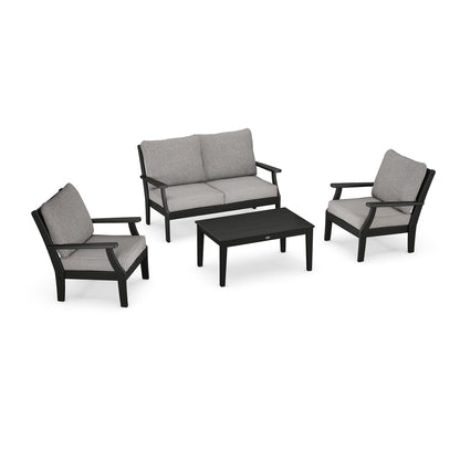 A modern outdoor furniture set featuring the POLYWOOD Braxton 4-Piece Deep Seating Chair Set, including two single chairs, one double sofa, and a rectangular coffee table, all in black with grey cushions and constructed from POLYWOOD® recycled plastic lumber.
