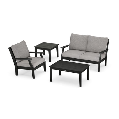 A modern POLYWOOD Braxton 4-Piece Deep Seating Set featuring a two-seater sofa, two armchairs, and a coffee table, all in black with gray cushions, displayed against a white background.